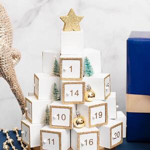 Celebrate the countdown to Christmas with our Christmas Advent Calendar Table Top Tree. This elegant 360-degree tree is crafted from white plywood and features 25 small, hinged boxes, each adorned with a number and a glittery edge. 

This advent calendar tree makes a delightful and interactive addition to your holiday décor, offering a touch of festive charm and anticipation for each day leading up to Christmas. 
Each box door is magnetised to stay securely shut, and perfectly sized for small treats or notes. Interspersed among the boxes are charming faux bottlebrush Christmas trees and small chrome gold baubles, adding festive sparkle to the design. The tree is topped with a glittery gold star and rests on a metallic gold platform base.

Standing 30cm tall and 29cm in diameter, this item is sold individually. 

The internal dimensions of each box are approximately 4cm deep, 3.5cm tall, and 2.5cm wide

ITEM: 33002464WH
.
.
#kochandco #kochinspo #adventcalendar #christmasdecor #christmasdecorations